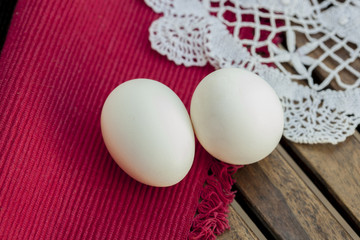 Two white Eggs isolated on wooden table.