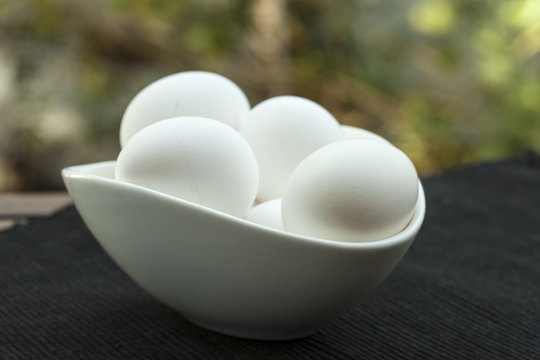 Eggs in a white bowl isoated on black background. 