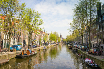 Fototapeta na wymiar Amsterdam canals with bridge and typical dutch houses.