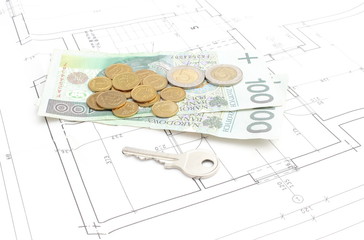 Money and silver key lying on the housing plan