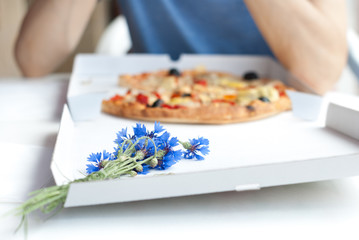 Eating pizza - Bunch of cornflowers on a pizza box