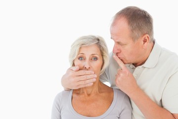 Man silencing his fearful partner