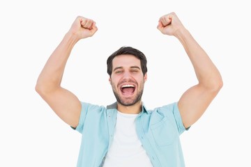 Happy casual man cheering at camera