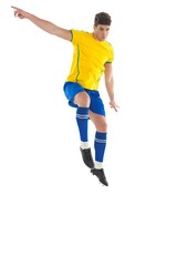 Football player in yellow kicking