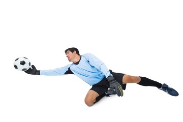 Naklejka premium Goalkeeper in blue making a save