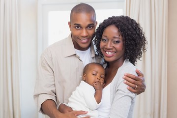 Happy young parents spending time with baby