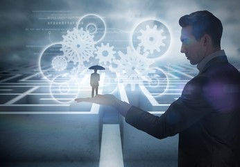 Composite image of businessman holding umbrella