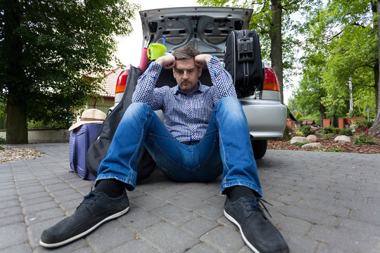 Upset Man And Car Full Of Luggage Bags