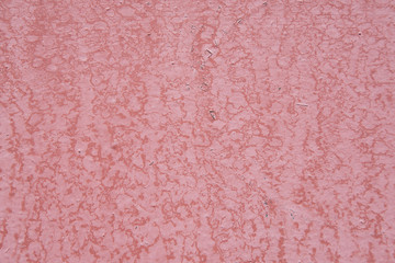 Pink textured pattern of old exterior wall