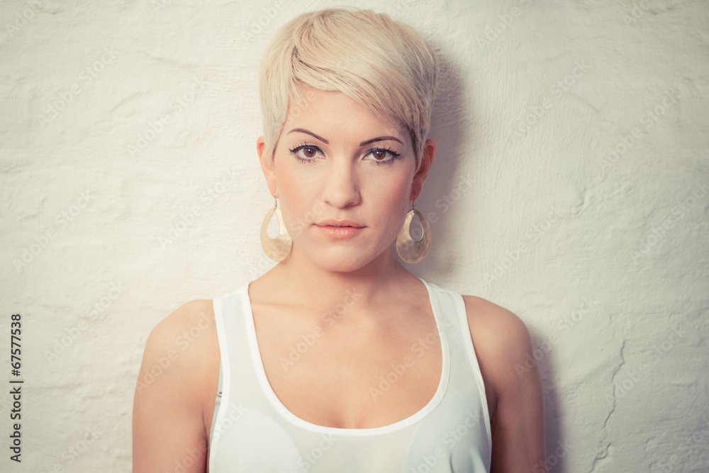 Wall mural portrait of a young woman with short blond hair