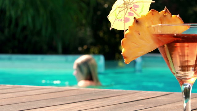Orange cocktail by the swimming pool at hotel