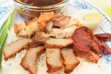 BBQ Pork, sausage, crispy pork over rice.