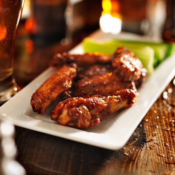 bbq chicken wings with celery on plate