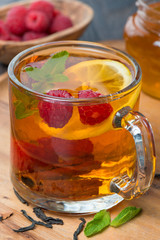 black tea with lemon, mint, raspberry and cinnamon, close-up