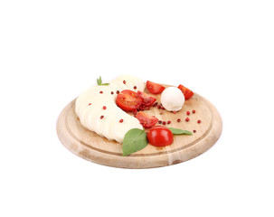 Caprese salad with pepper on platter.