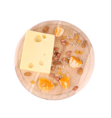 Cheese on board with nuts and orange.