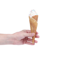 Hand holds cone vanilla ice cream.