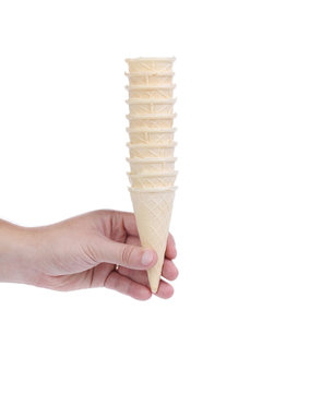 Hand hold stake of ice cream cones.