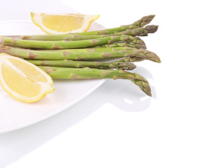 Bunch of asparagus on a plate.