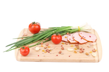 Close up of ham with nuts on board.