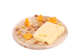 Cheese on board with nuts and orange.