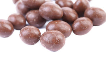 Dark brown dragee in chocolate cover.