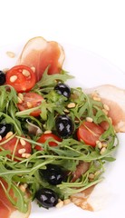 Salad with arugula and prosciutto.