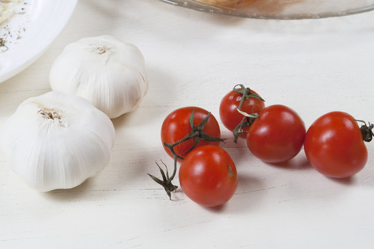 Fresh cherry tomato and garlic on the table.