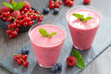 milkshake with fresh berries and mint in glass, top view