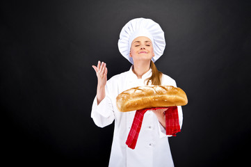 Chef baker smelling fresh baked bread.