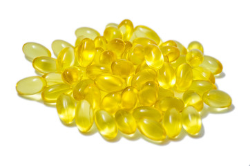 Capsules of fish oil and vitamins side view