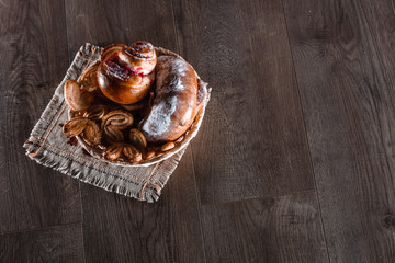 buns in wicker basket on wooden table. copyspace