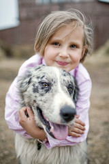 Girl playing with a Border Collie