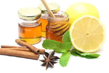 Honey and lemon on white background