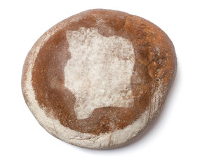 A loaf of fresh bread covered with rye flour in the shape of Ivo