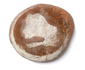 A loaf of fresh bread covered with rye flour in the shape of Sen