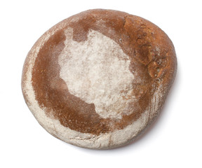 A loaf of fresh bread covered with rye flour in the shape of Tan