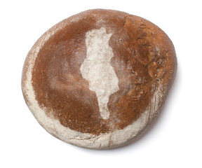 A loaf of fresh bread covered with rye flour in the shape of Tun