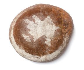 A loaf of fresh bread covered with rye flour in the shape of Aze