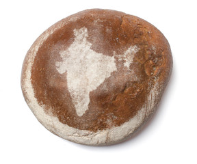 A loaf of fresh bread covered with rye flour in the shape of Ind
