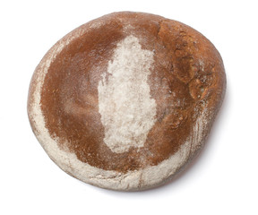 A loaf of fresh bread covered with rye flour in the shape of Qat