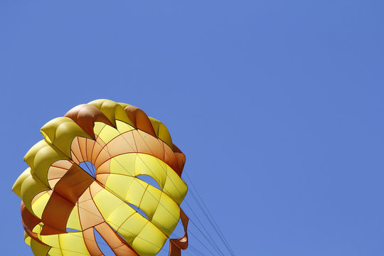 Parasailing against blue sky