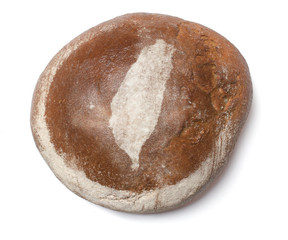 A loaf of fresh bread covered with rye flour in the shape of Tai