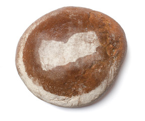 A loaf of fresh bread covered with rye flour in the shape of Yem
