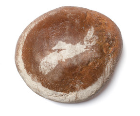 A loaf of fresh bread covered with rye flour in the shape of Nov