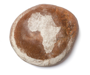 A loaf of fresh bread covered with rye flour in the shape of Afr