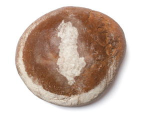A loaf of fresh bread covered with rye flour in the shape of Alb