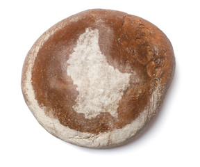 A loaf of fresh bread covered with rye flour in the shape of Lux