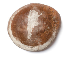 A loaf of fresh bread covered with rye flour in the shape of Arg