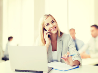 businesswoman with phone in office